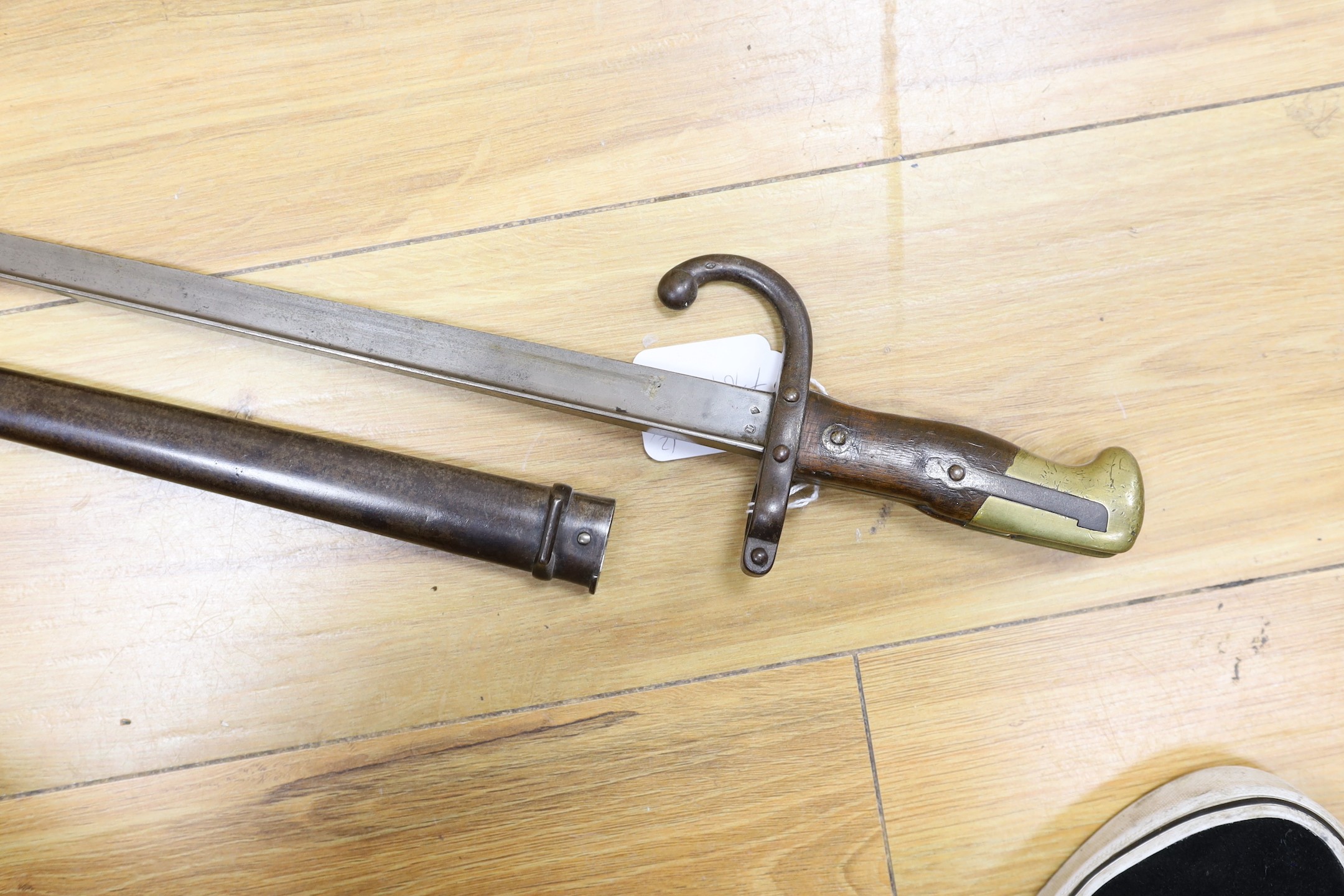 A Victorian officer's sword, lacking sheath, together with a 19th century French ’1877’ bayonet and sheath